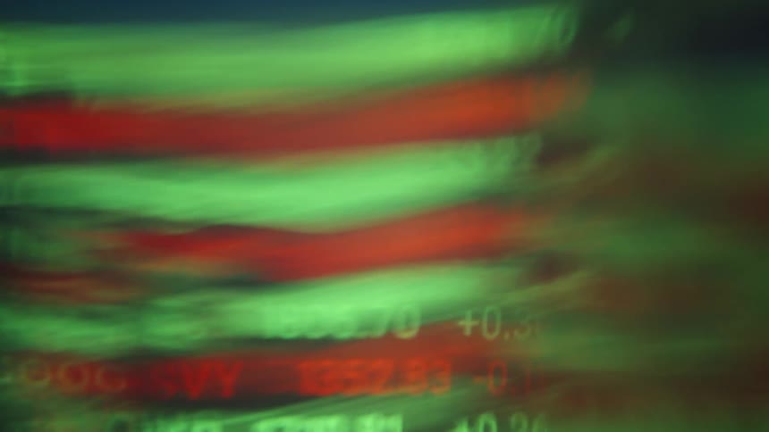 Blurry stock ticker numbers flash on a screen