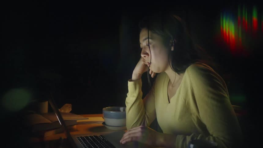 A woman using a laptop in a room