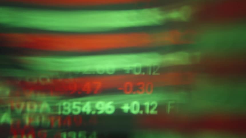 Stock numbers and ticker symbols in red and green displayed with blur effect
