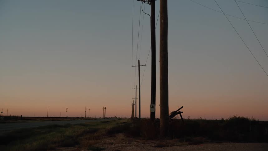 A view of a landscape with sunset in the distance