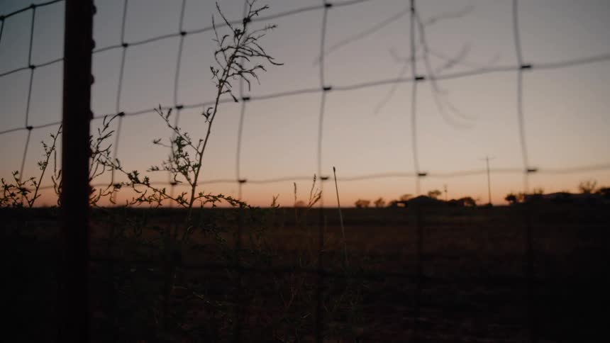 A view of a landscape with sunset in the distance