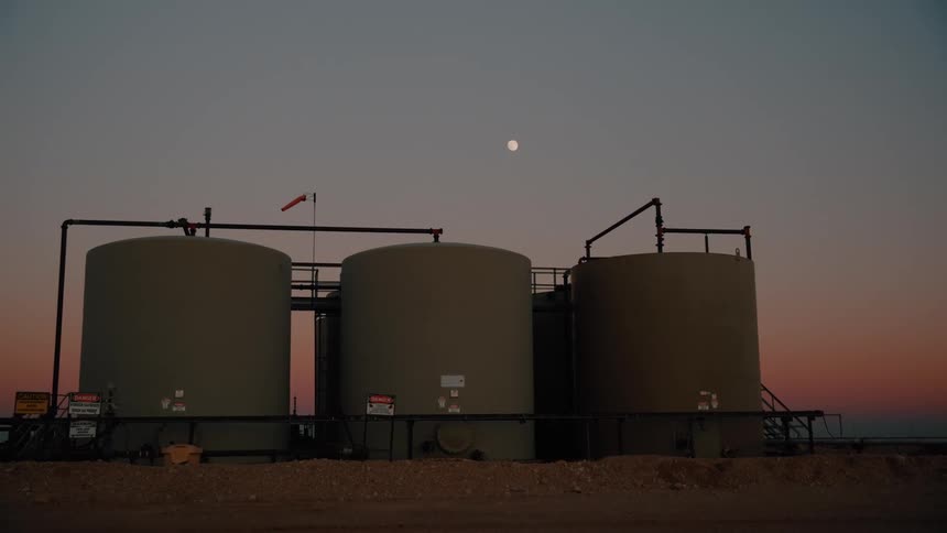 Danger signs in front of oil storage tanks