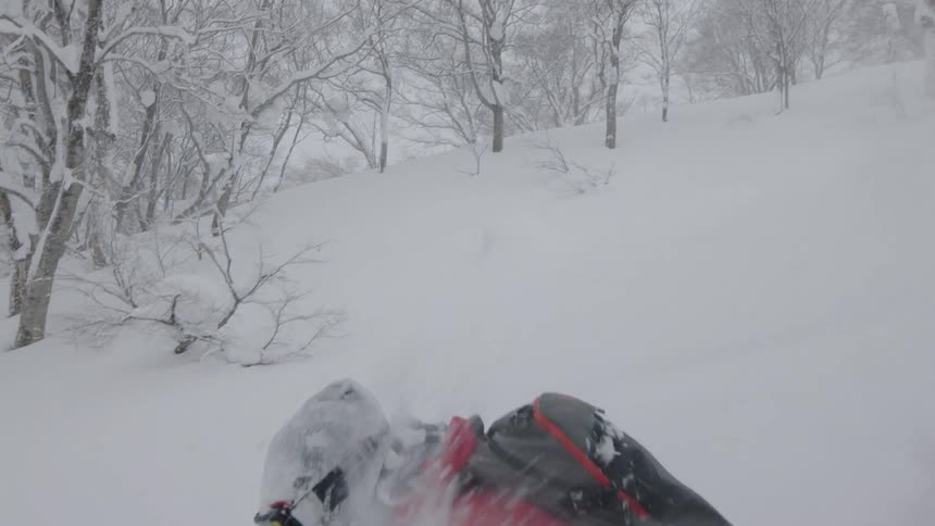 A person skiing down a mountain covered in snow