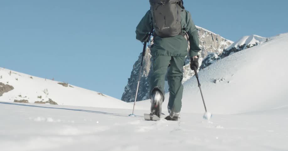 A man hiking up a snowy mountain