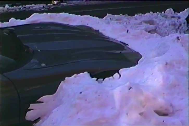 The car is covered with heavy snow