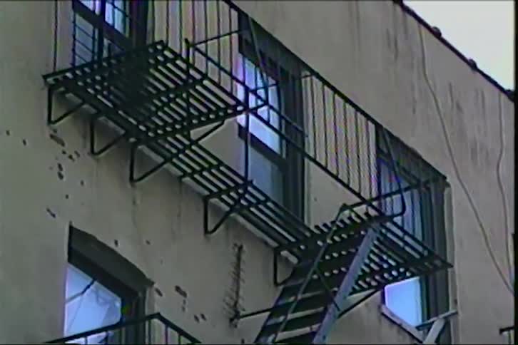 The fire escape runs up the side of the apartment building