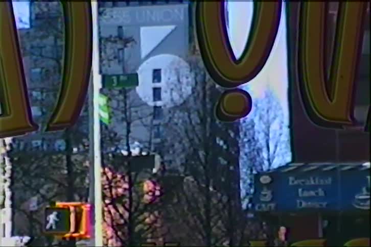 Traffic and buildings on a metropolitan area seen through the display window of a shop during day time
