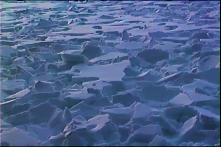 Vast expanse of broken ice sheets covering body of water