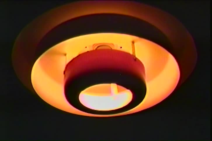 Ceiling light fixture emitting warm orange glow