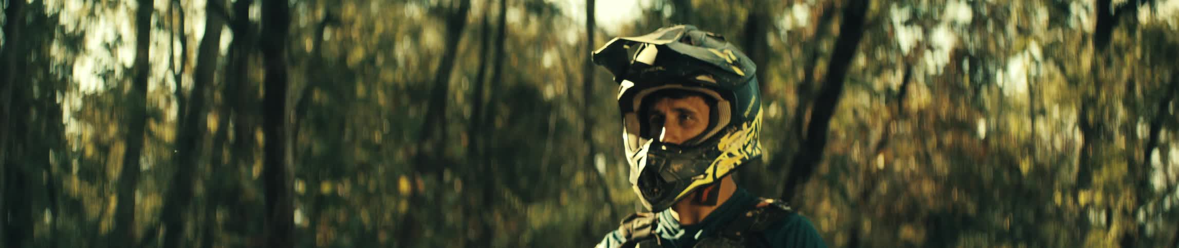 Man takes off his goggles from around his helmet