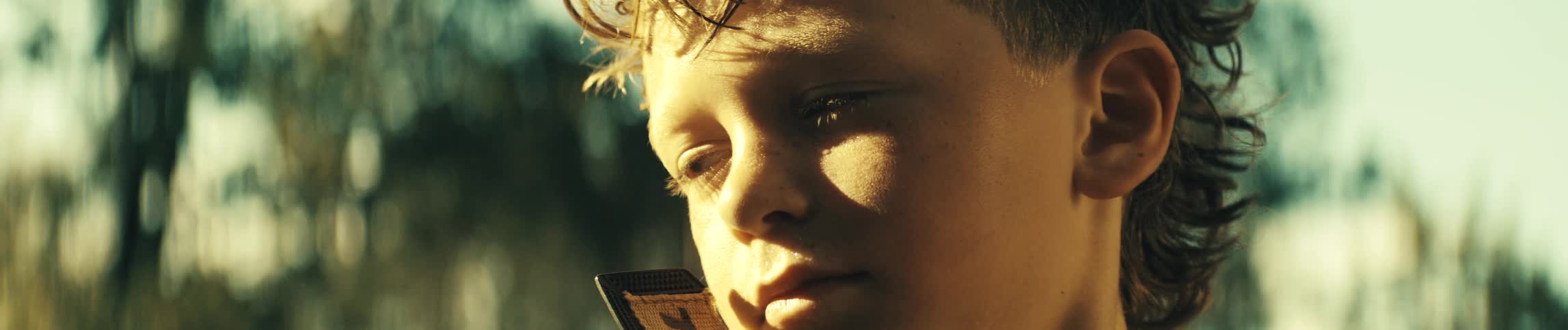 The boy is smiling and blinking his eyes