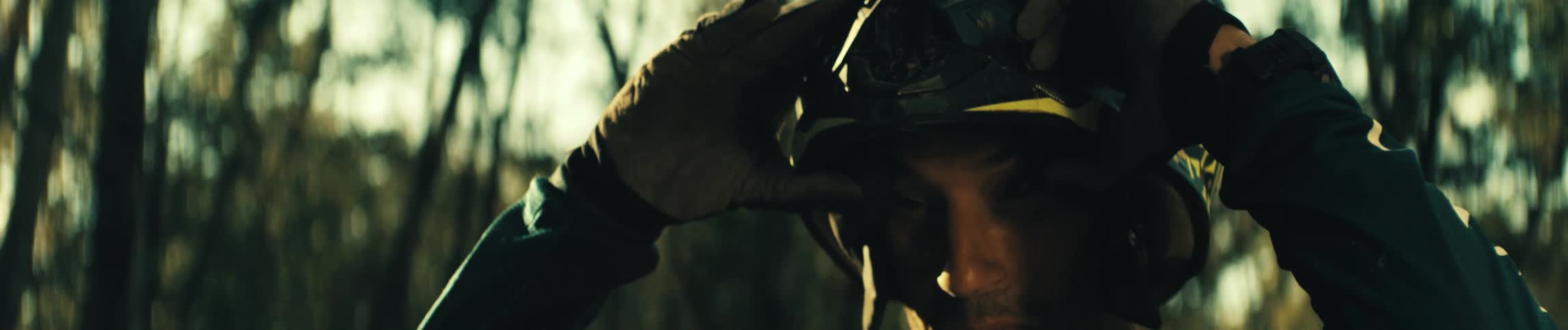 The man removes his crash helmet