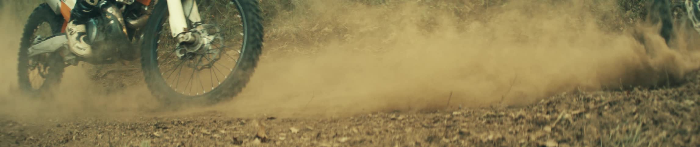 Two dirt bikes out in the dirt