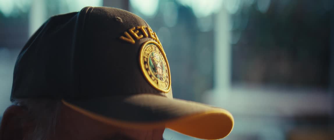 Cap with veteran inscription and embroidered emblem seen up close in a welllit indoor setting