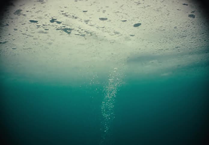 Sweedish Ice Saw cutting hole in frozen lake
