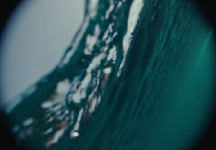 Underwater view of ice with sunlight piercing surface