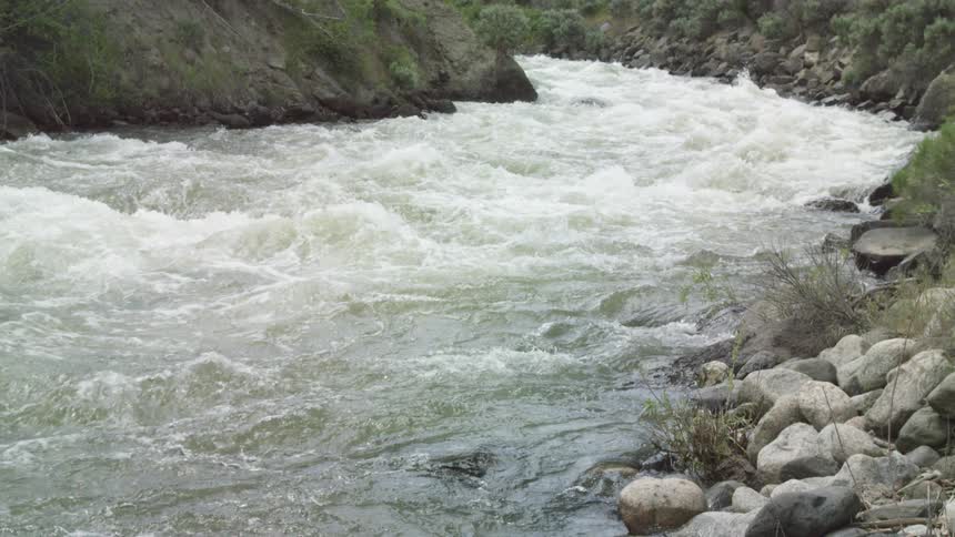 The river water rushes around the curve