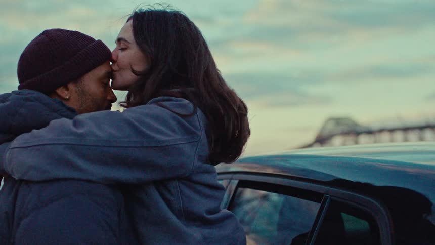 A couple kissing outside