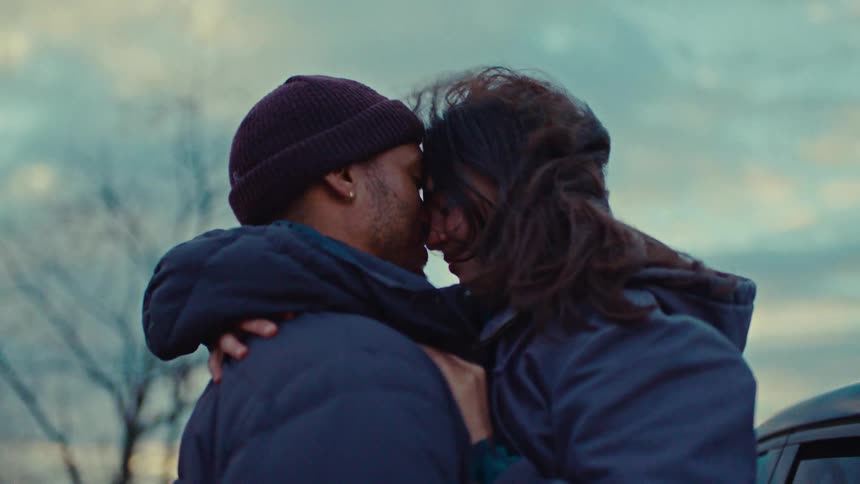 Couple embracing with their foreheads touching outdoors