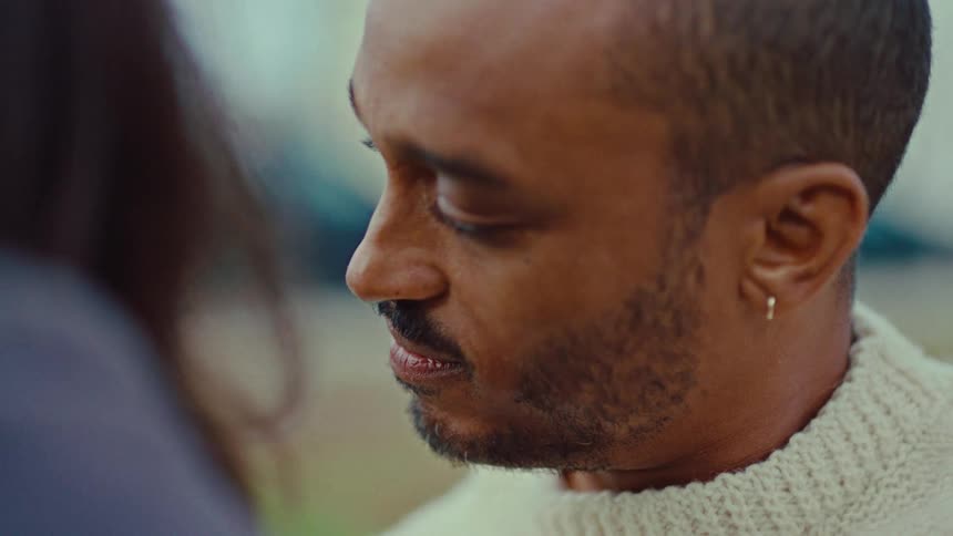 Man looking at a woman outdoors