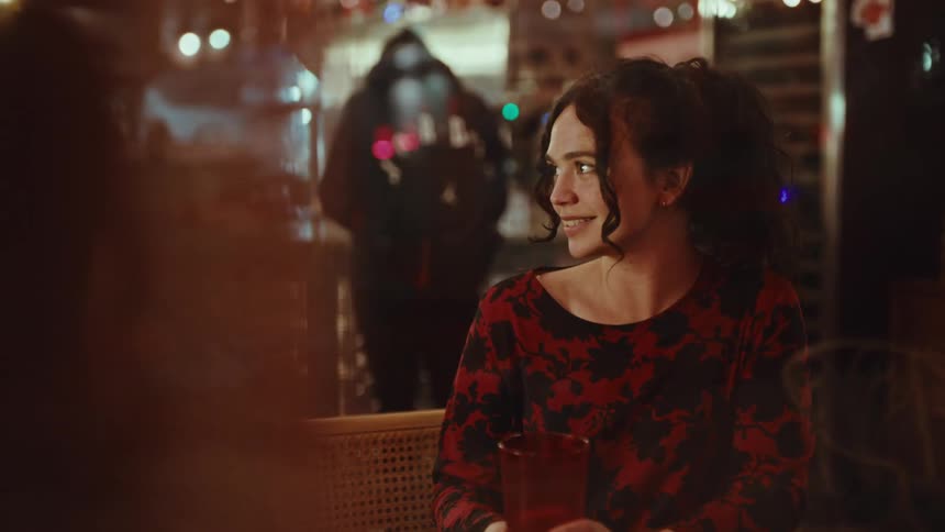 Woman smiling while seated at a table in a restaurant