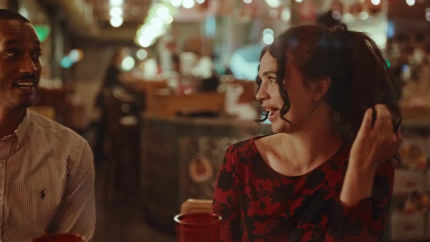 Couple talks while sitting in a restaurant during a date