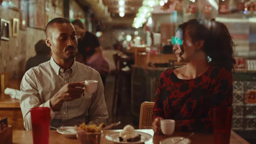 A man and woman having food and drinks