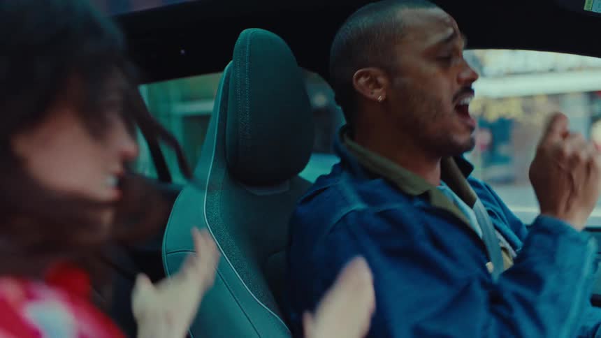 The man and woman are singing in the car