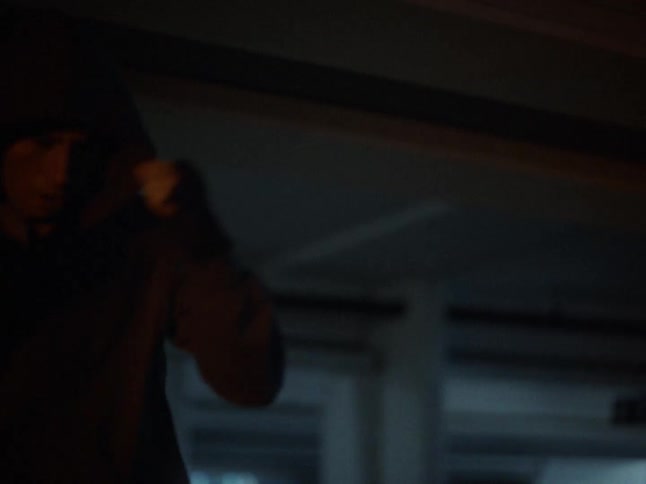 A man practicing boxing in a parking lot