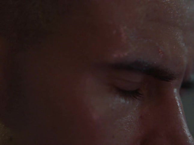 Closeup of a sweaty mans face focused on the eyes