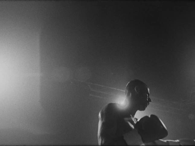 A man boxing and throwing punches in a ring
