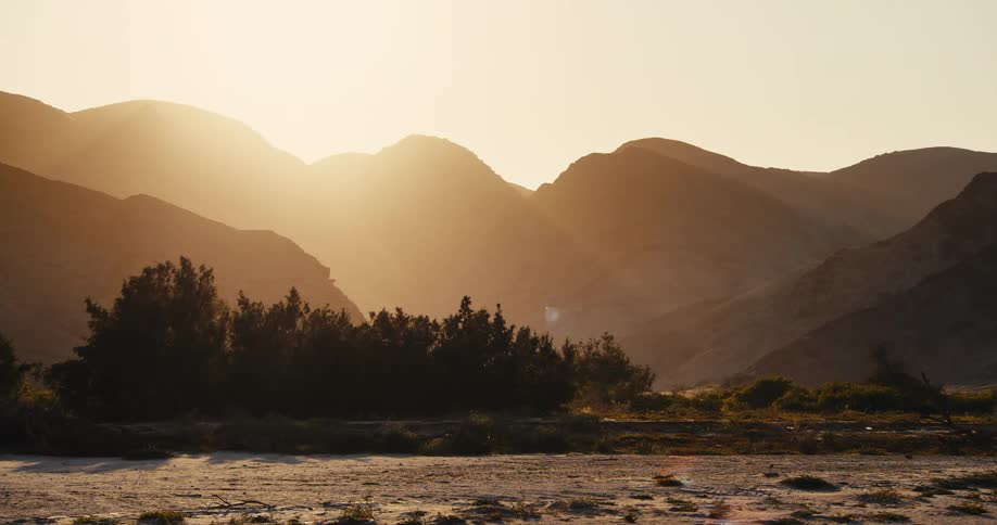 A view of a landscape in the desert with mountains
