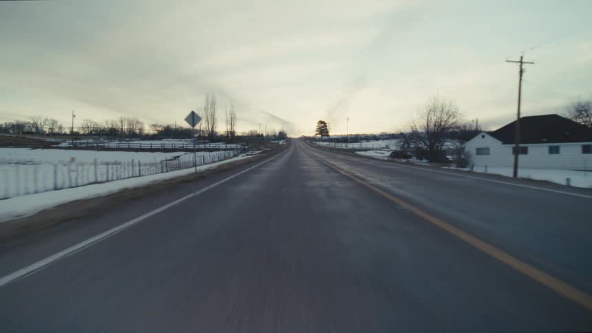 A view of snow on either side of a road