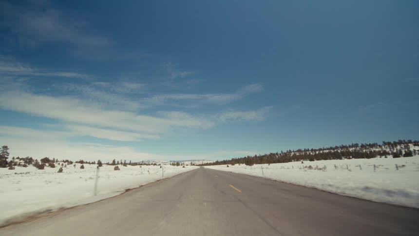 A view of a road with snow on either side