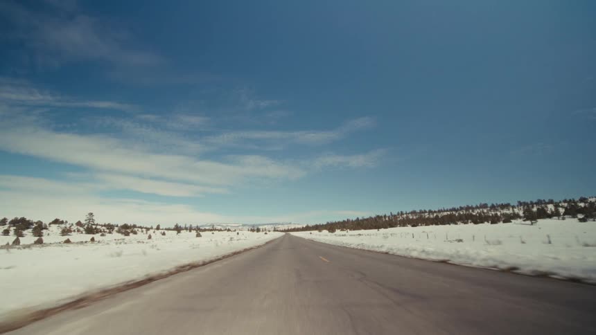 A view of a road with snow on either side