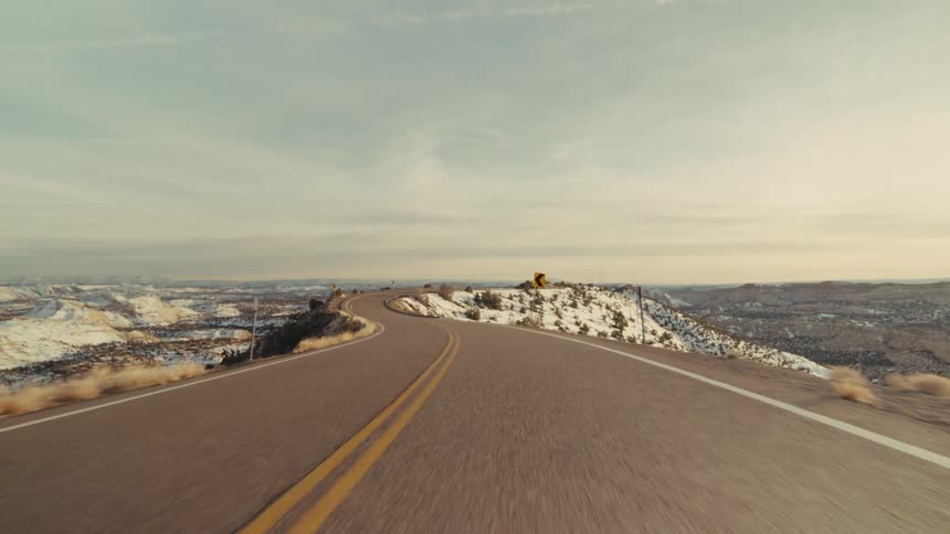 A view of a road in a mountain covered in snow