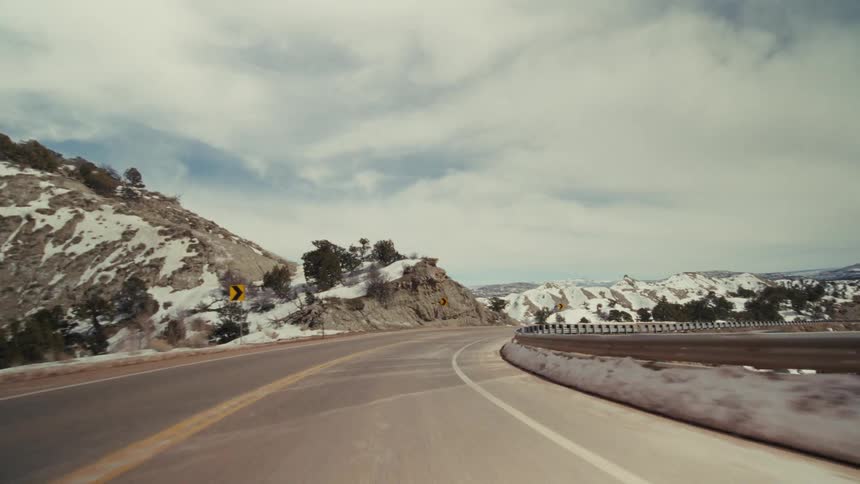 A view of a road on a mountain covered in snow