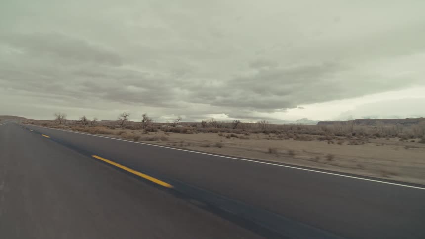 A view of a desert landscape next to a road