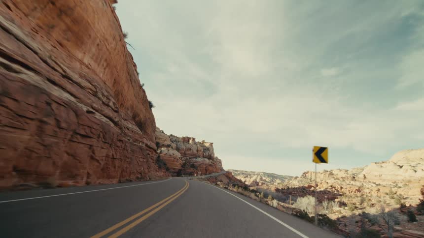 The highway runs through the tall canyon