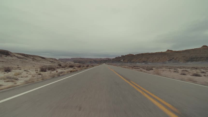 Traveling on a desert road through mountains and canyons