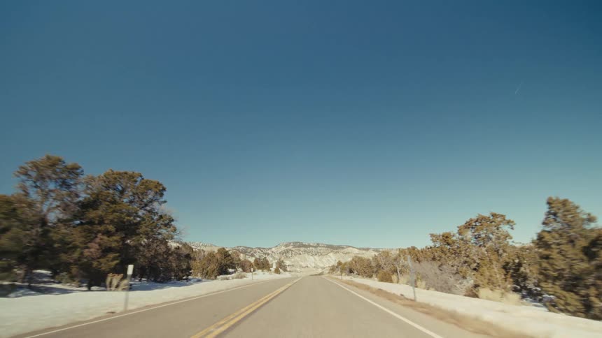 The highway leads to the mountain range ahead