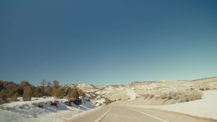 The highway leads to the mountain range ahead