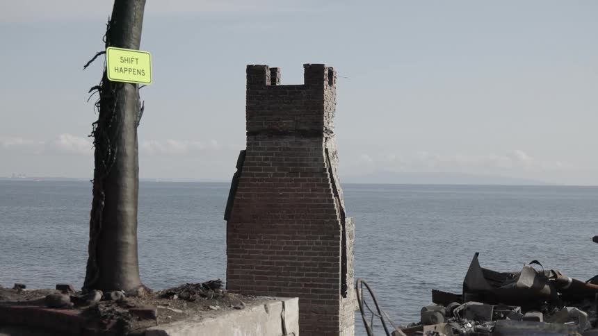 Rubble of destroyed buildings is located close to the coastline