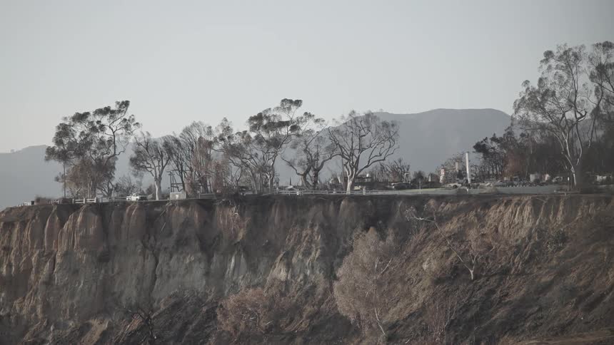 Partially collapsed highway with landslide at dawn