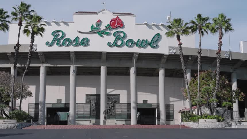 The iconic rose bowl stadium is lined with several palm trees