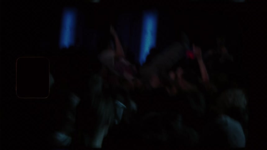 This video captures the highenergy atmosphere of a crowded underground music venue filmed with a grainy vintage aesthetic it features a band performing on a dimly lit stage while the audience dances and moves rhythmically to the music