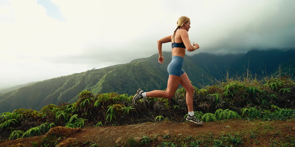 A woman running outdoors on a sunny day