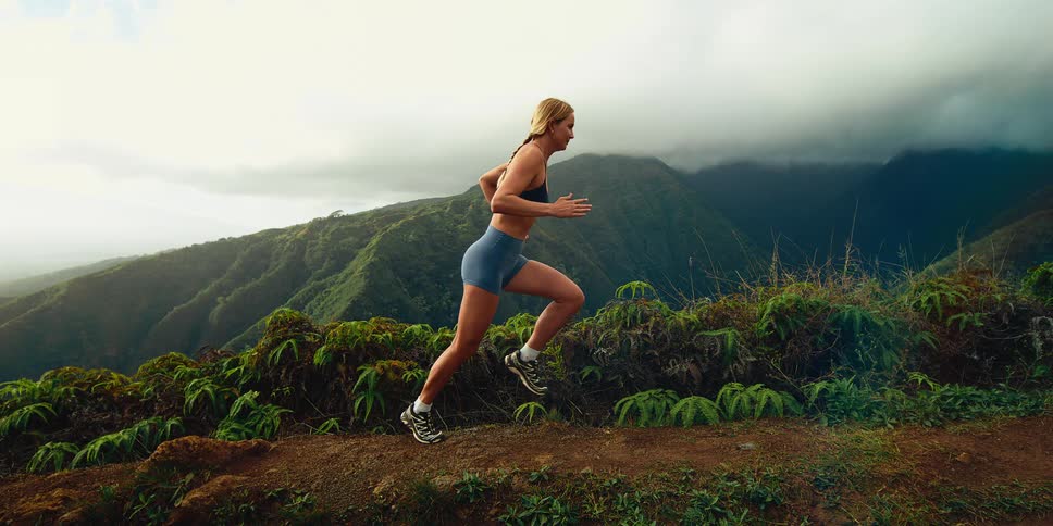 A woman running outdoors on a sunny day