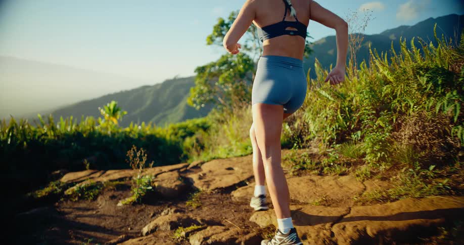 A woman running outdoors on a trail