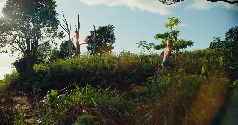 Woman jogs on a mountain trail surrounded by plants and vegetation